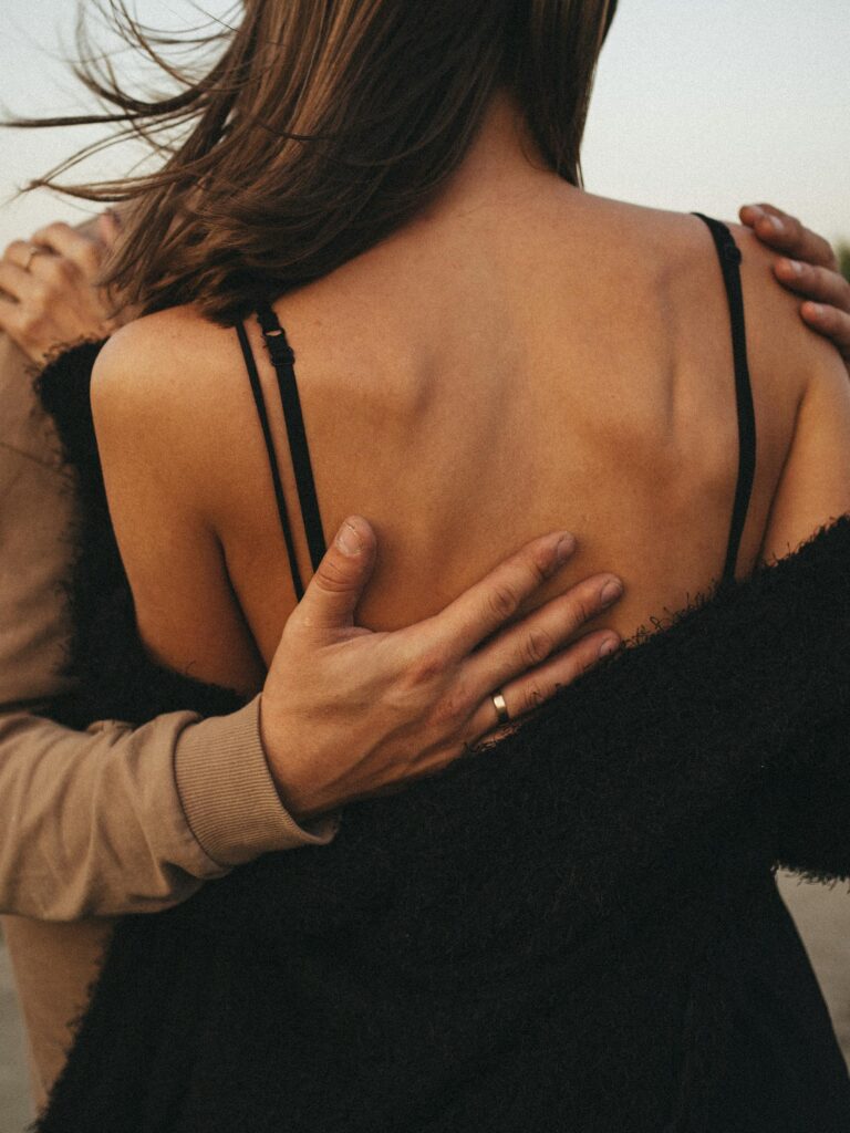 A close-up back view of a couple embracing, conveying warmth and affection.